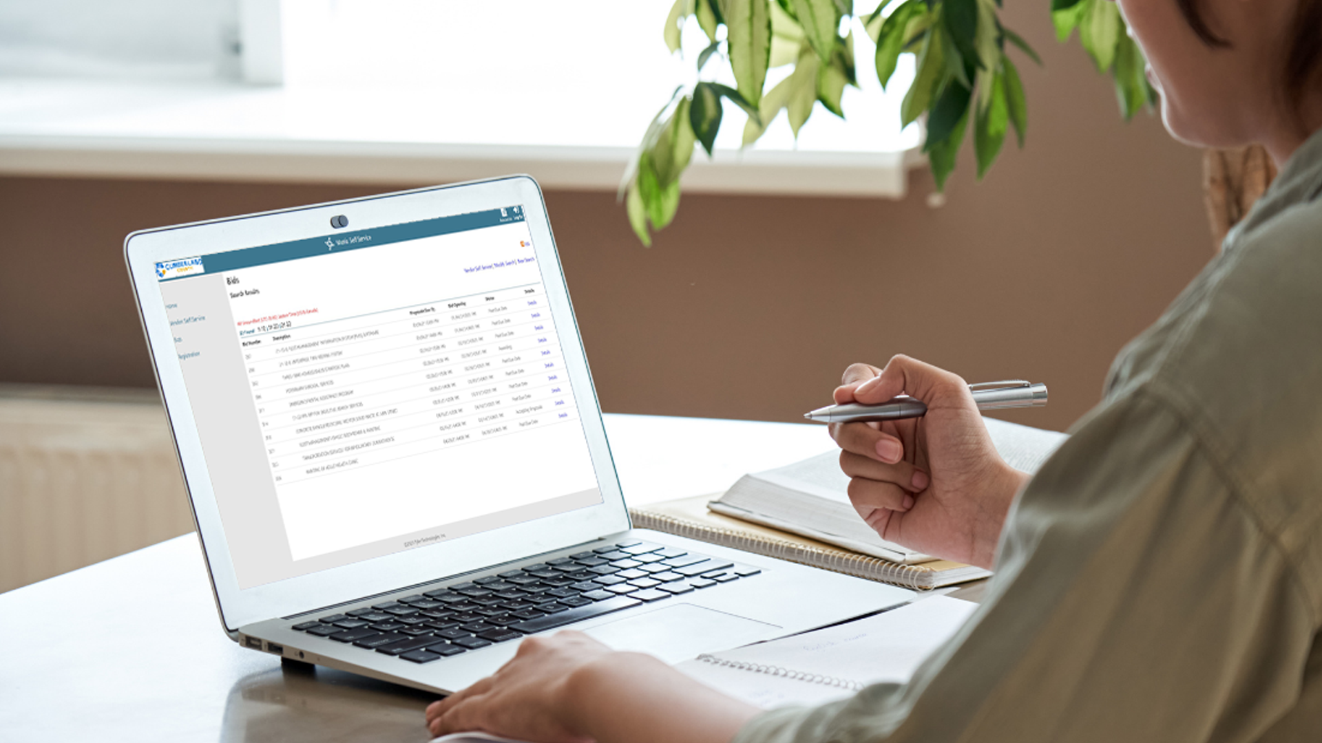 Person at table working on a laptop
